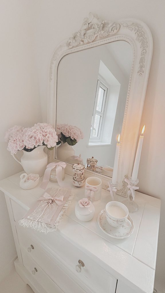 Shabby chic vanity decor with gold mirror candles and flowers