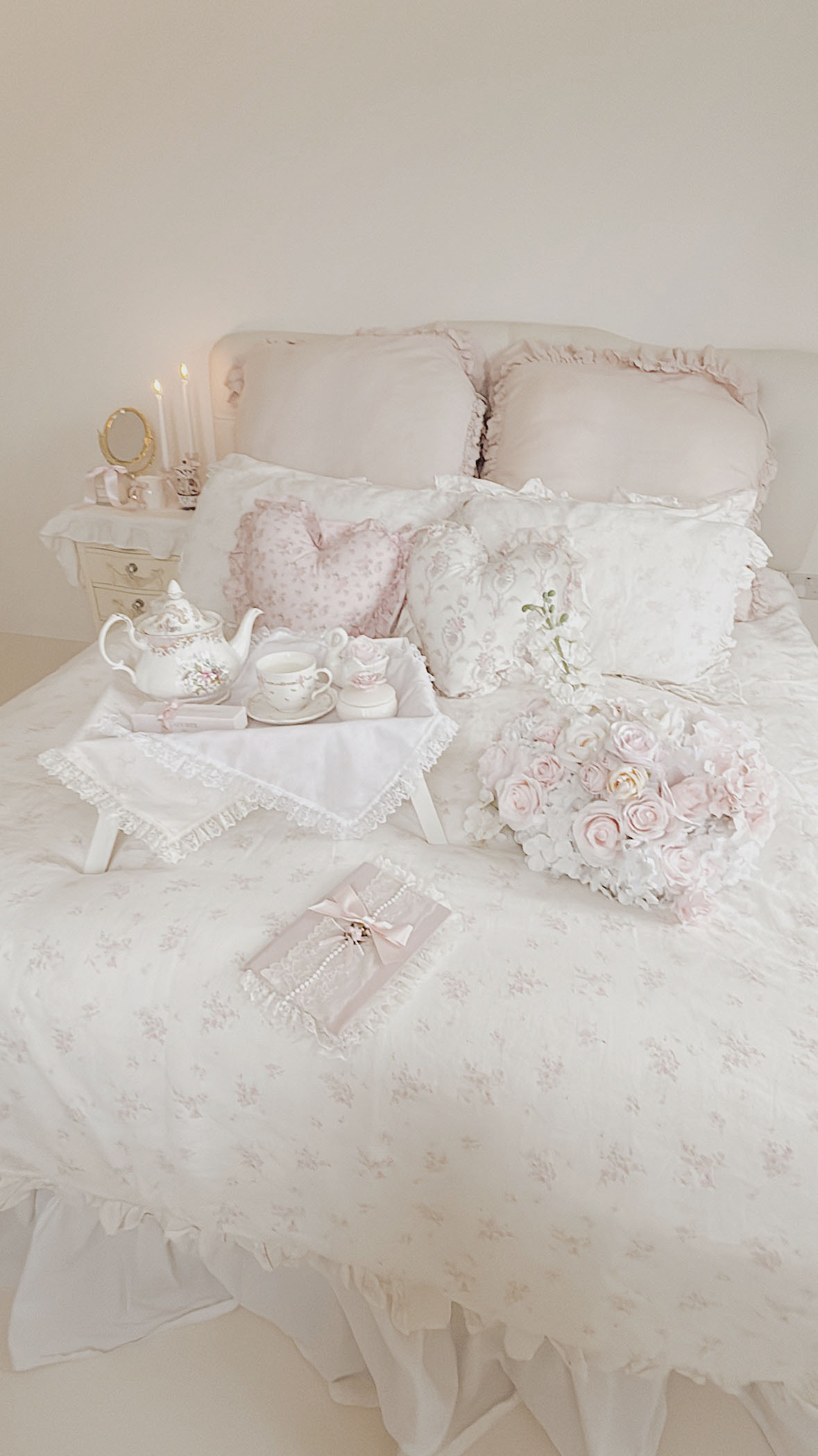 Shabby chic floral ruffled bedding with pink roses in a romantic bedroom