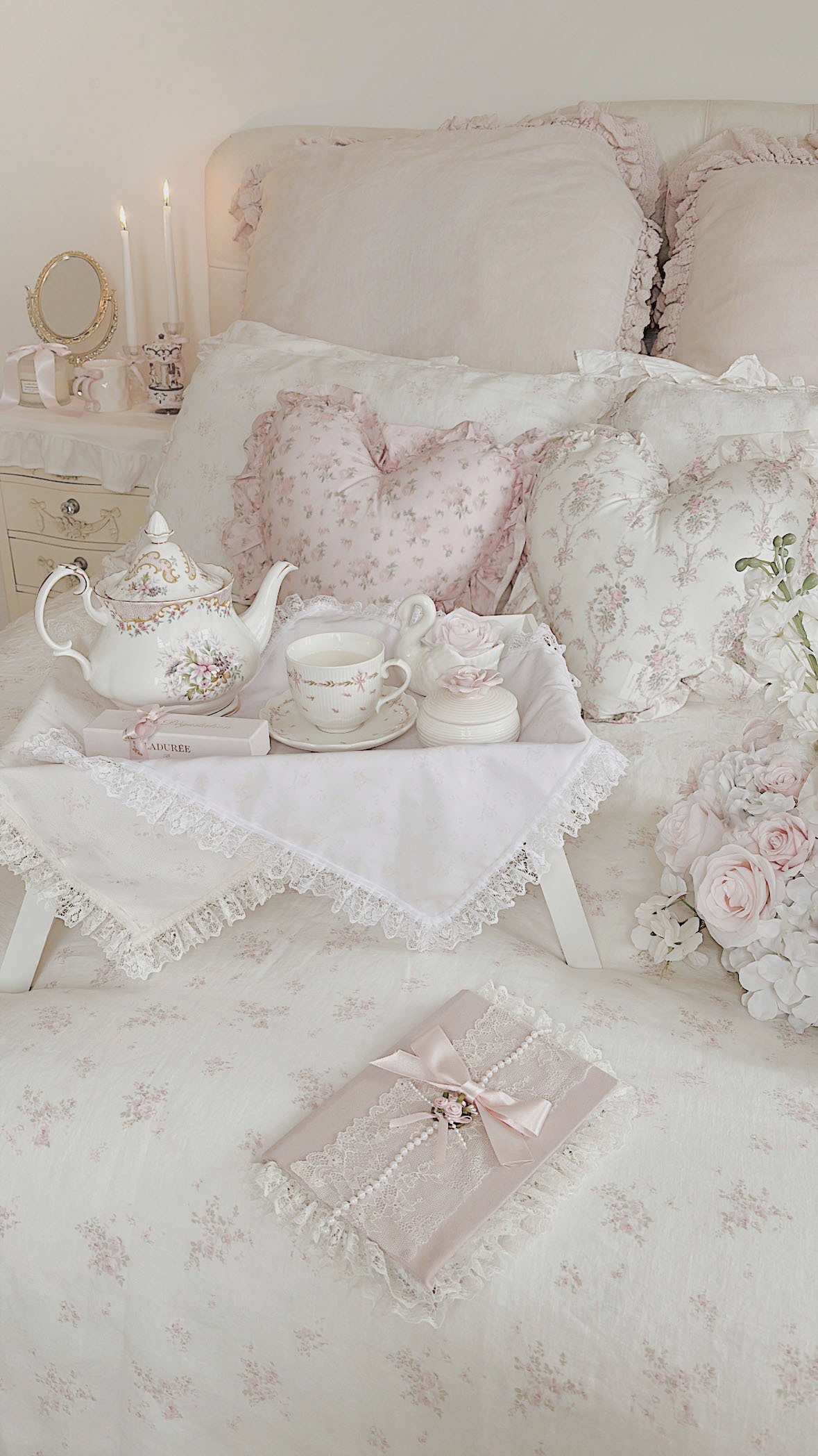 Romantic shabby chic diary with lace details on a ruffled bed