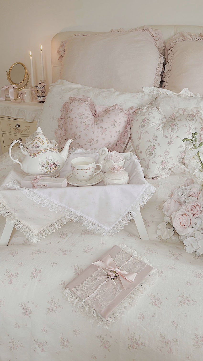 Shabby chic floral ruffled bedding with pink roses in a romantic bedroom