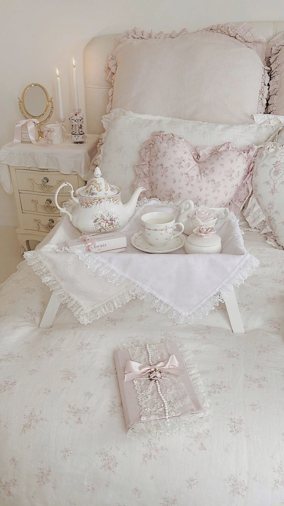 Shabby chic floral ruffled bedding with pink roses in a romantic bedroom