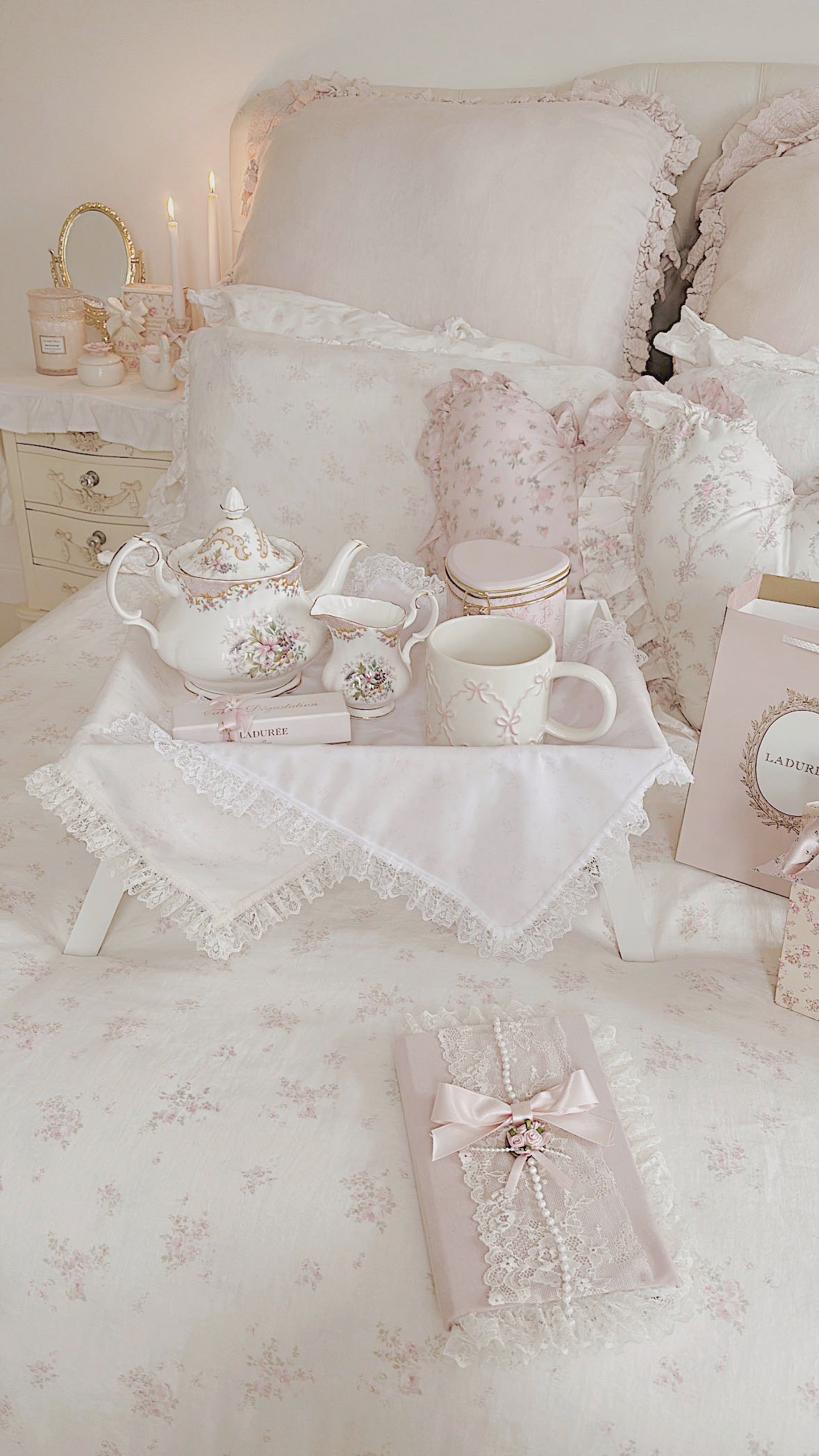 Dreamy shabby chic floral bedding with romantic ruffled pillows, a tea tray, vintage teapot, and a cute pink bow mug by La-Vania.
