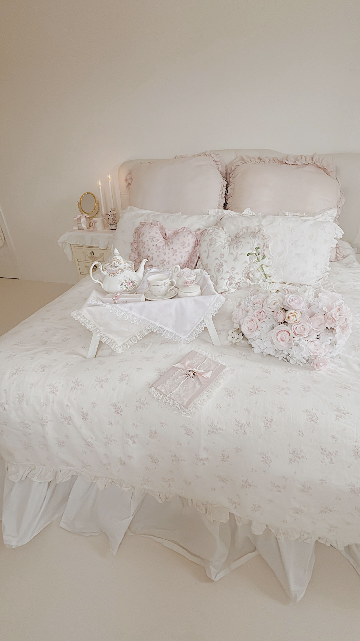 Romantic ruffled bedding with a vintage lace diary in a coquette shabby chic bedroom
