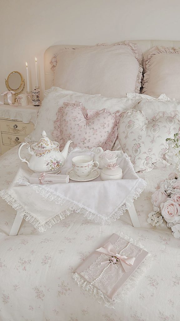 Shabby chic floral ruffled bedding with pink roses in a romantic bedroom