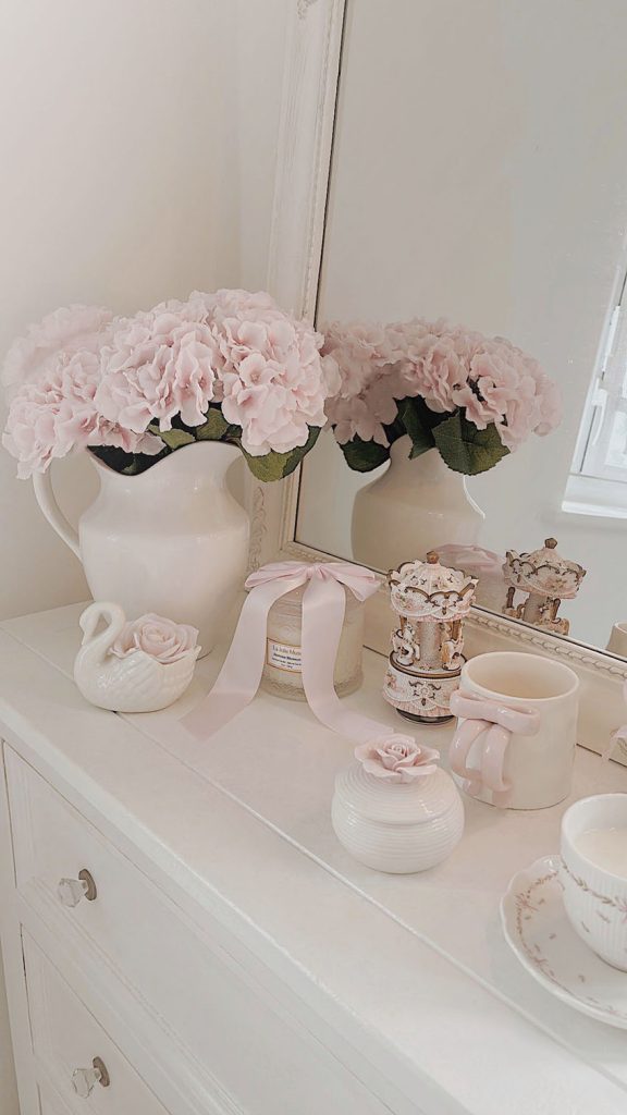 Shabby chic vanity decor with gold mirror candles and flowers