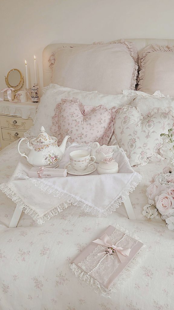 Romantic ruffled bedding with a vintage lace diary in a coquette shabby chic bedroom