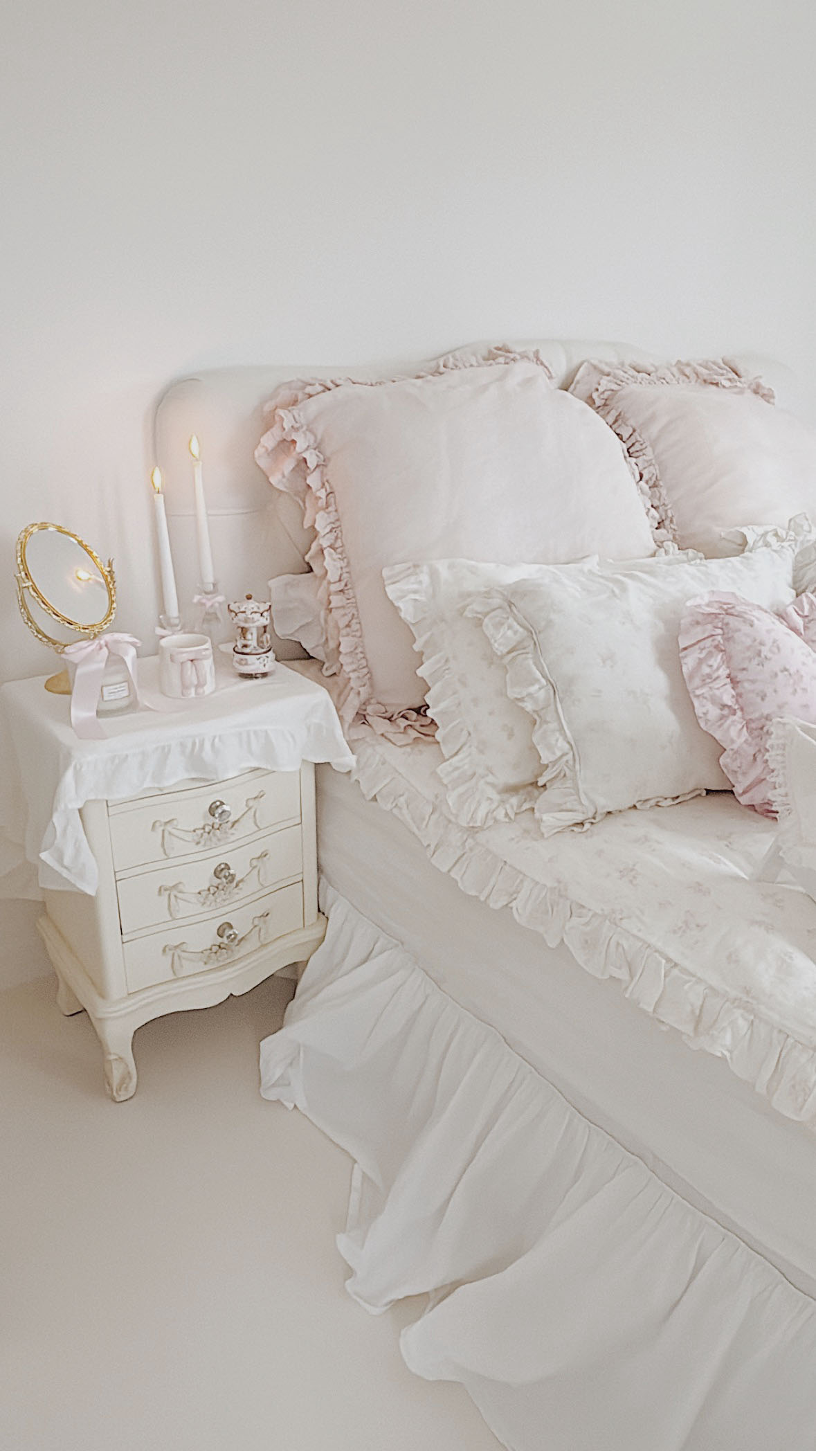 Shabby chic floral ruffled bedding with pink roses in a romantic bedroom