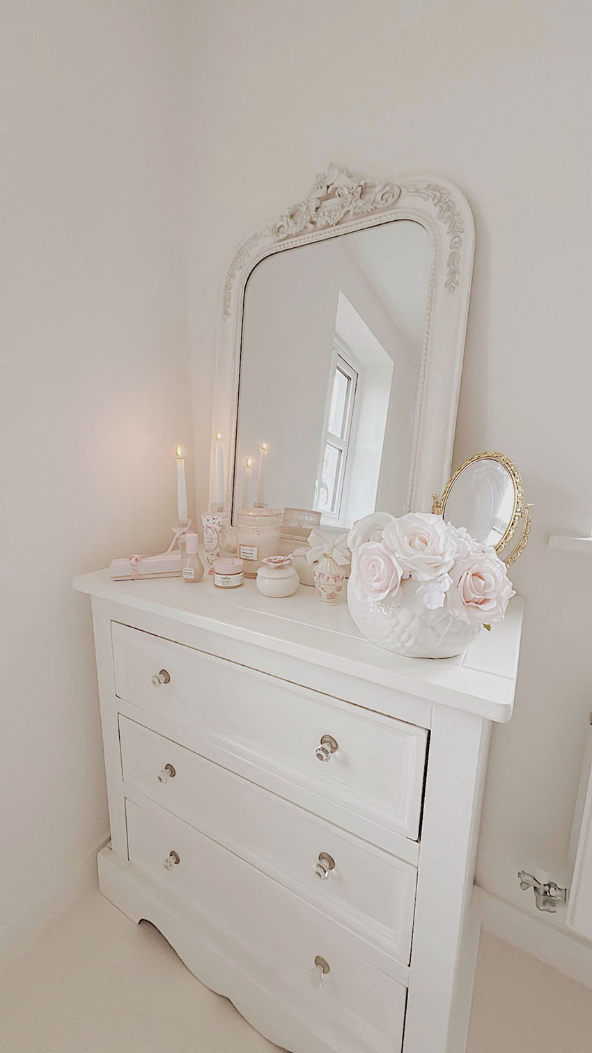 Aesthetic vanity decor featuring Ladurée Paris chocolates, Glow Recipe dew drops, a La Jolie Muse scented candle, and vintage mirrors by La-Vania.