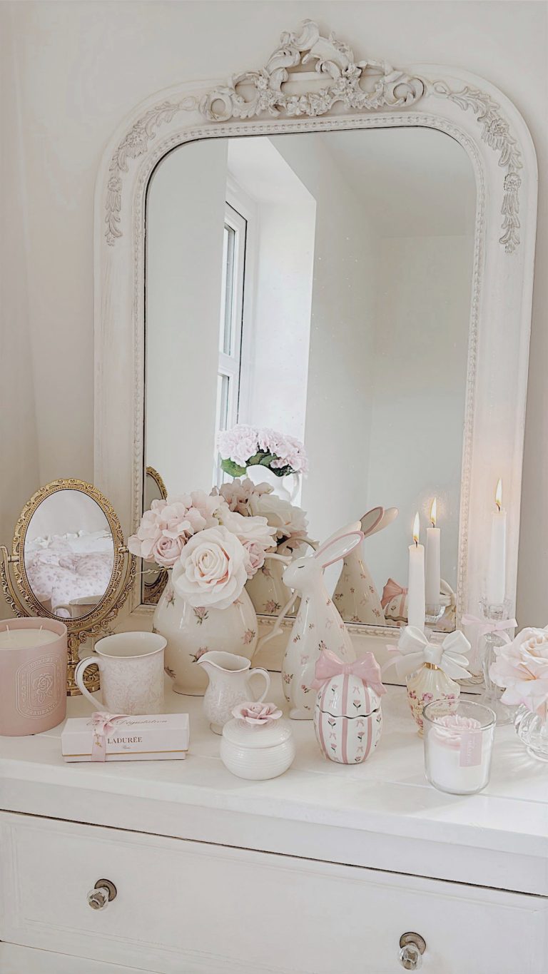 Romantic shabby chic vanity decorated for Easter with a handpainted bunny pastel spring flowers and a pink rose trinket box