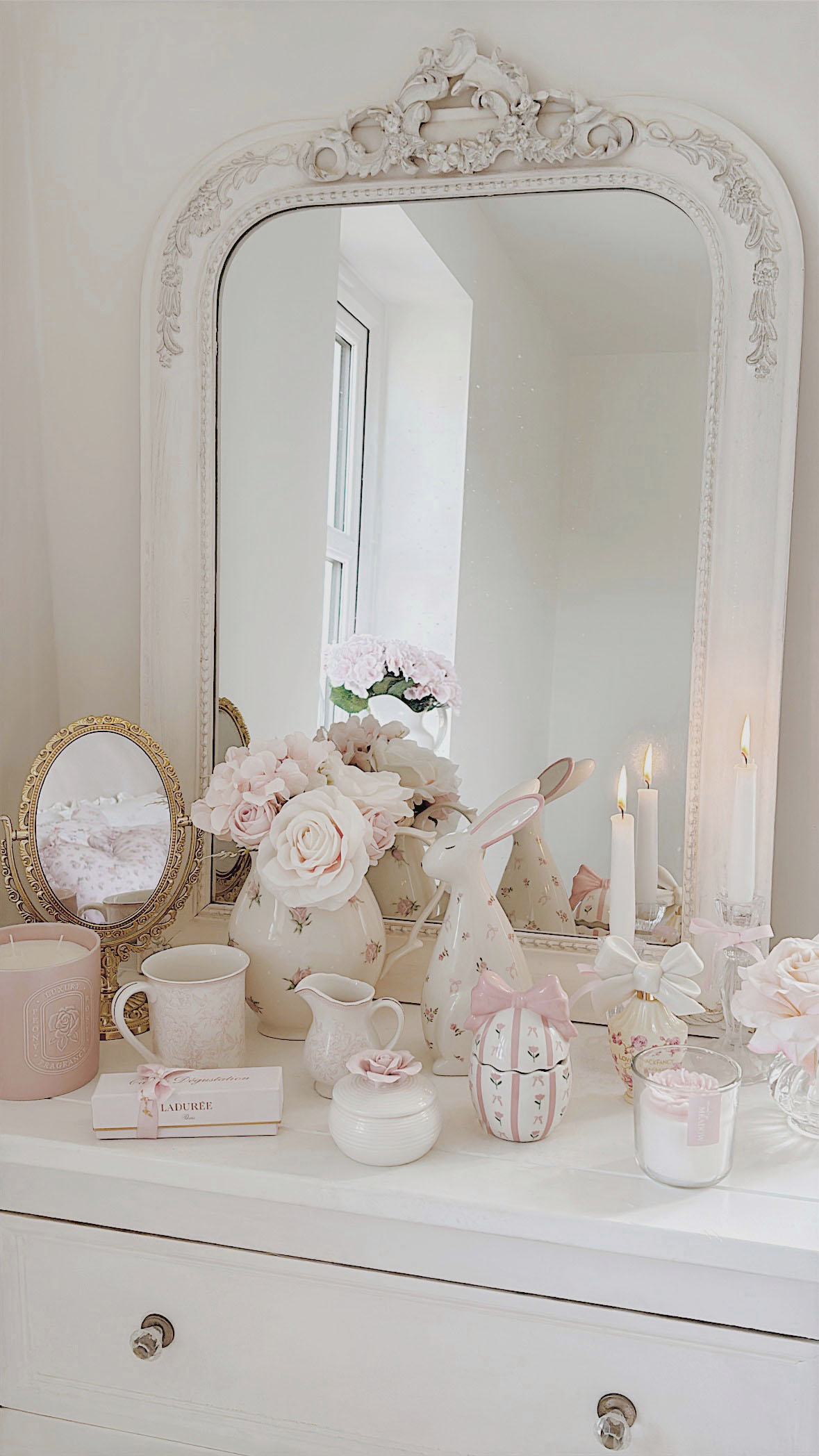 Romantic shabby chic vanity decorated for Easter with a handpainted bunny pastel spring flowers and a pink rose trinket box