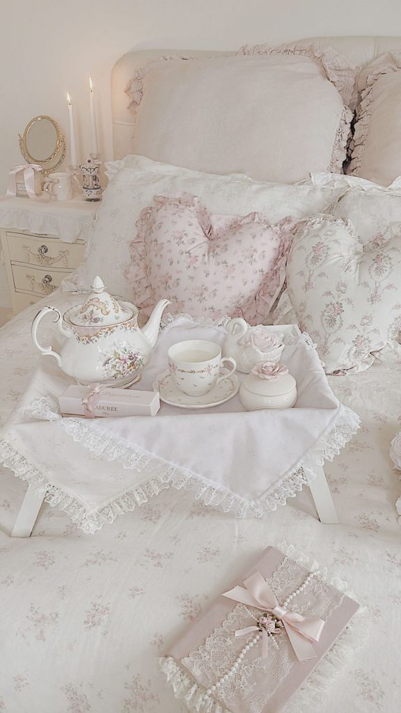 Romantic ruffled bedding with a vintage lace diary in a coquette shabby chic bedroom